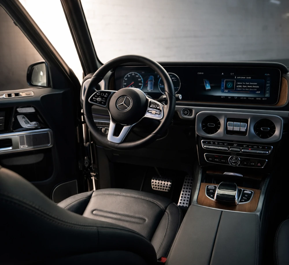 Mercedes-Benz G550 interior with steering wheel, dashboard and center console