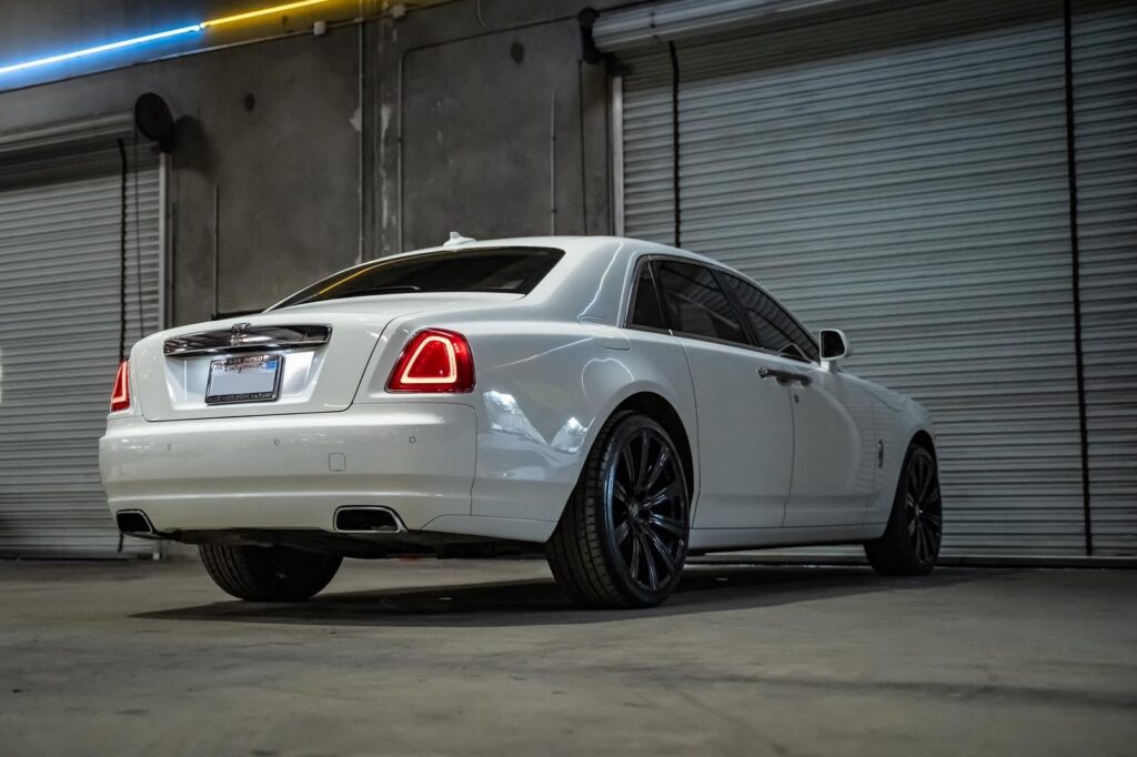 White Rolls-Royce Ghost luxury sedan - rear three-quarter view