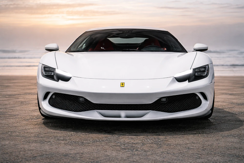 White Ferrari 296 GTB hybrid supercar - front view in San Diego