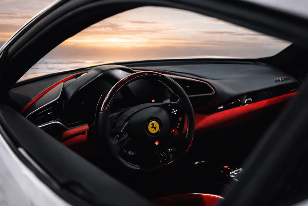 Ferrari 296 GTB driver cockpit with steering wheel, dashboard and red interior