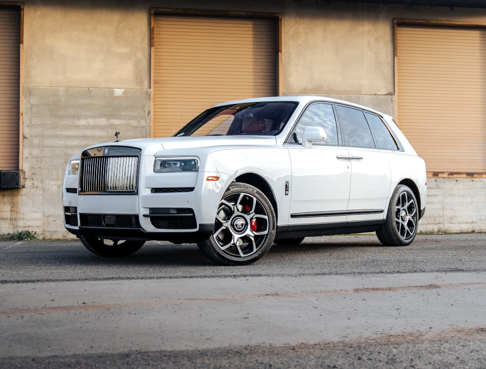 White Rolls-Royce Cullinan Black Badge rental in San Diego - front three-quarter view