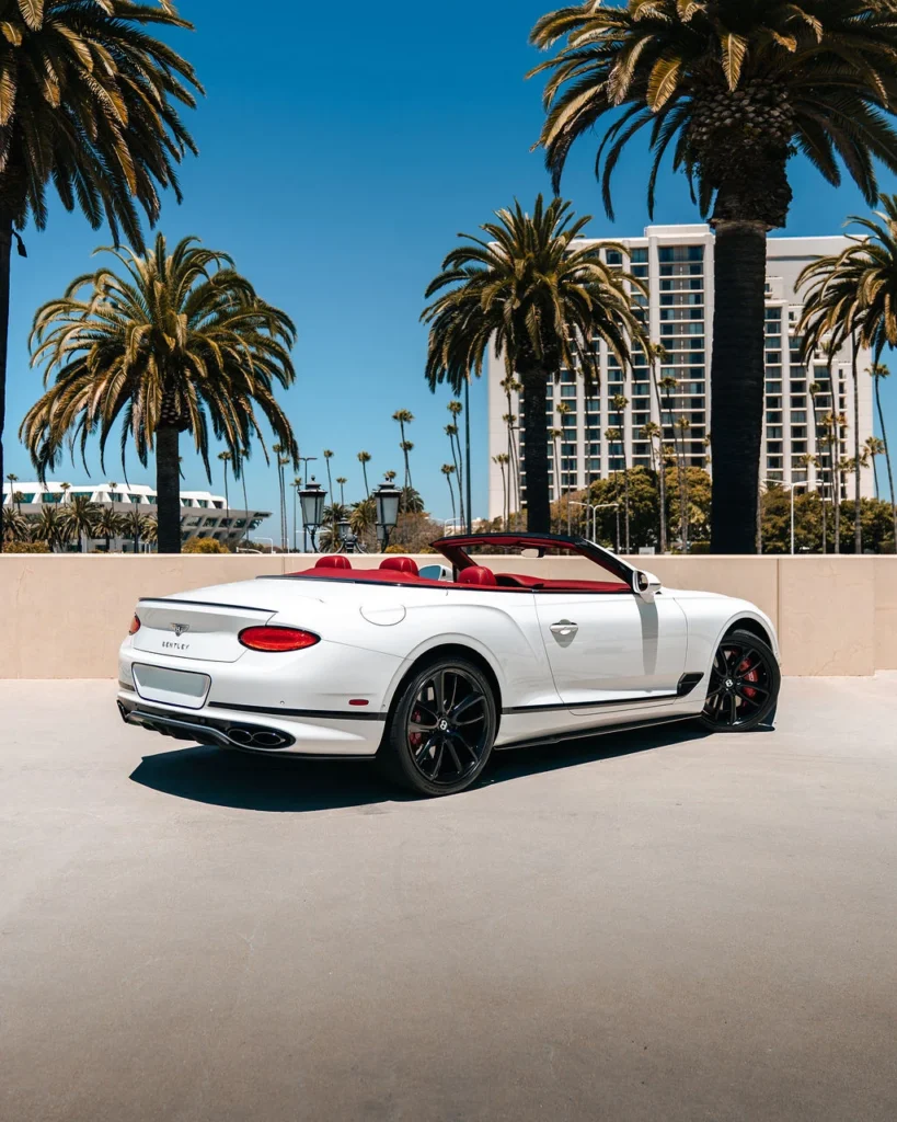 White Bentley Continental GTC rental in San Diego - rear three-quarter view with red interior