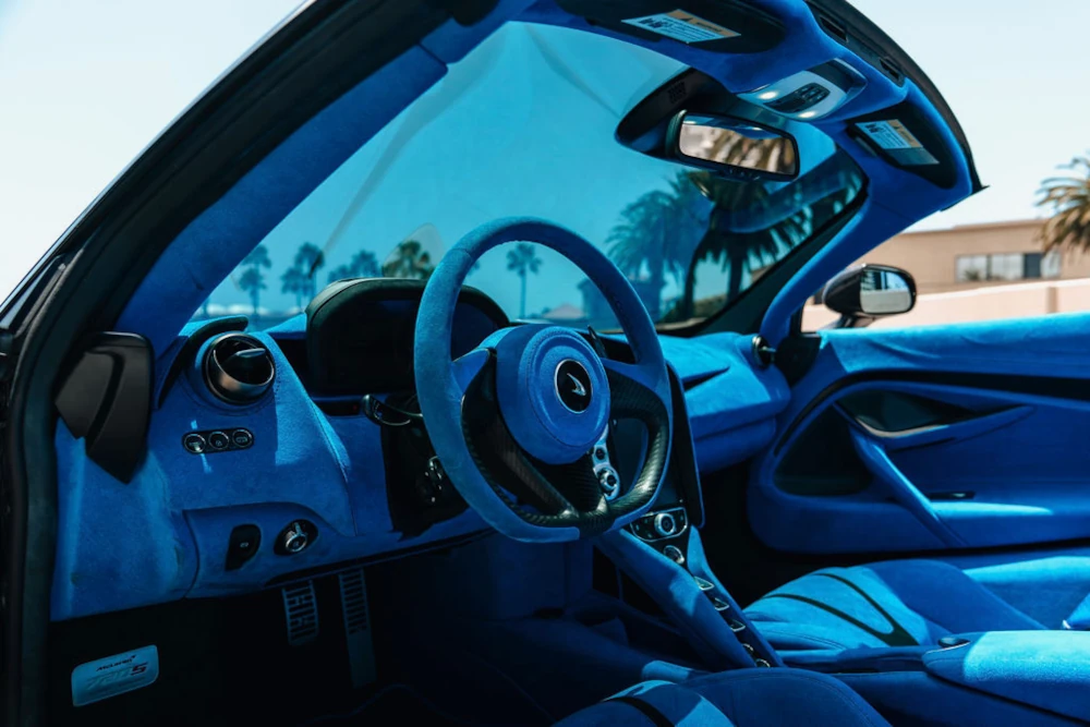 McLaren 720S MSO Tokyo Cyan driver cockpit with steering wheel and dashboard